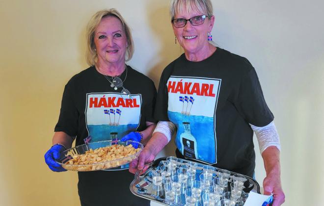 Noreen Carpenter and Jeanette Bjornstad prepare the hákarl and brennivin for the appetizer table.