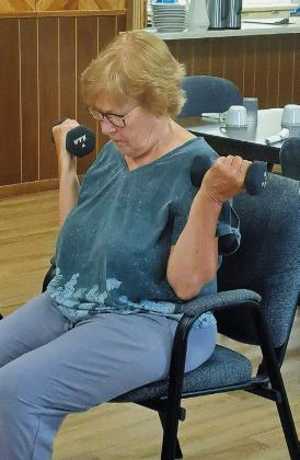 Glenda Erickson pumping iron at the workout group. Photo by Christine Jensen.