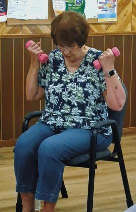 Jan Aasand doing bicep curls. Photo by Christine Jensen.