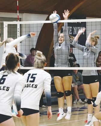 Emily Gonzalez and Claire Thompson both go for a dig against the NB Eagles. Photo by Larry Stokke Kiara Assand with a stuff block against the North Border Eagles . Photo by Larry Stokke.