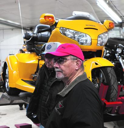 Lloyd Thompson and Darrell Aipperspach check out the motorcycles at Street is Neat in Oslo with a bright yellow Honda trike in the background. Photo by Lyle Van Camp.