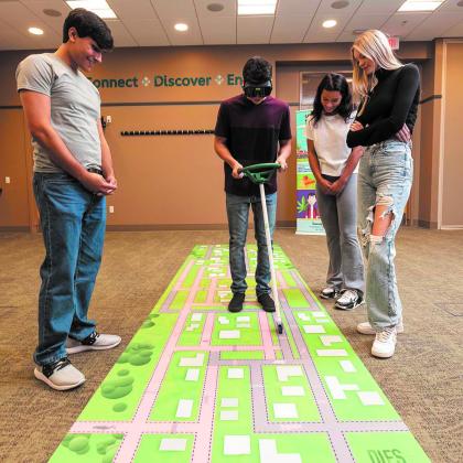 Students were challenged to steer a car on a track while wearing Polydrug Goggles that distorted their view as if intoxicated. Submitted photo.