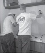 Ron and Rob Boll installing shelving for the obituary collection and binders. Submitted photo.