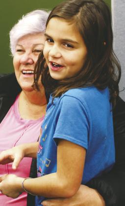 Ciera Dalzell visits with her grandmother Mary Dalzell at the crafts market on Saturday. Photo by Lyle Van Camp.