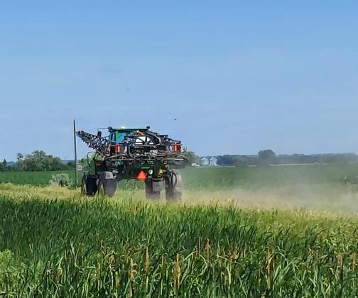 The slow-moving vehicle sign on this sprayer increases visibility and warms motorists to slow down. (NDSU photo)