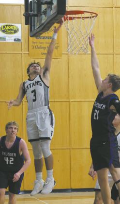 DVE’s Trenten Keena puts up the shot as Hatton-Northwood forward Drew Iverson. Photo by Jamie Rarick