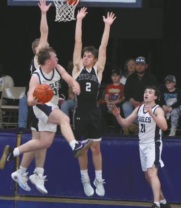 North Border's Kade Schafer attempts to move the ball to teammate Brody Berg past DVE defender Teddy Otto. Photo by Jamie Rarick