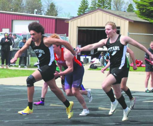 With a final baton handoff, teammates Mason Pollestad and Carter Oberg finish off the Men's 4X100 relay, winning the event for the region. Photo by Jamie Rarick