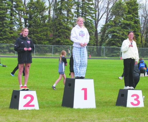 Competitors of the Women's Pole Vault take the podium at the NDHSAA North East Regional Track Meet in Mayville. In third place from Pembina County North: Addelyn Manley, in second place from Larimore: McKinley Moen, and regional champion from Drayton/Valley-Edinburg: Alyssa Hoyles with a height of 10' 6'. Photo by Jamie Rarick