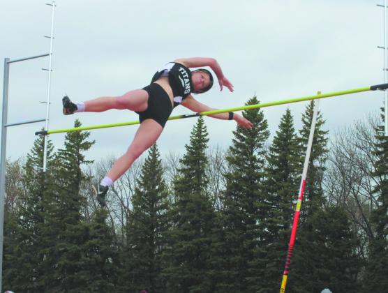 Winning by a distance of over one foot, DVE senior Alyssa Hoyles sails over the bar to clear 10' 6', locking in the title of regional champion in Women's Pole Vault. Photo by Jamie Rarick
