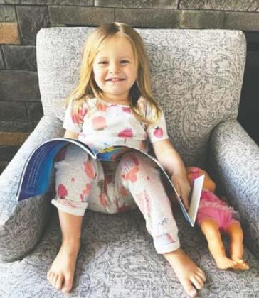 Maren Jacobson, age 3, enjoys reading an Imagination Library book.