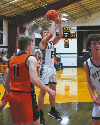 Isaac Feltman drops in a basket to help the Titans win over Cavalier by two points. Photo by Larry Stokke