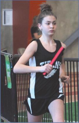 Elizabeth Fedje running in the girls 4 X 300 Relay. Photo by Lyle Van Camp.