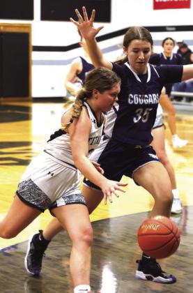 Brooke Gullickson drives past North Prairie's Morgan Casavant.