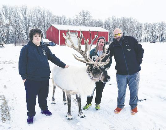 Austin, Olaf, Shannan, and Kyle pose for a family photo at Reindeer Ranch. Photo by Hilary Nowatzki.