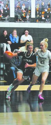 Moving from the outside, Brooke Gullickson drives towards the basket past Nelson County defender Brandi Lippert. Photo by Jamie Rarick