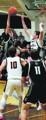 Quinn Passa jumps for the ball following a ricocheted rebound. Photo by Jamie Rarick