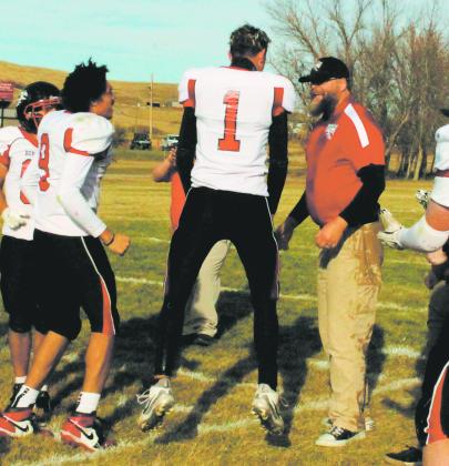 After soaking Head Coach Nathan Foster in ice water, the team celebrated on the sideline following clinching a championship victory. Photo by Jamie Rarick.