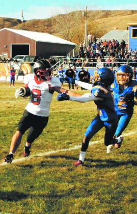 Drayton's Carter Johnson stiff-arms Trenten defender Tae Slater to advance the run. Photo by Jamie Rarick.