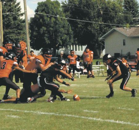 Bomber defenders Trenten Keena and Lucas De Souza dive for a Warwick fumble. Photo by Jamie Rarick