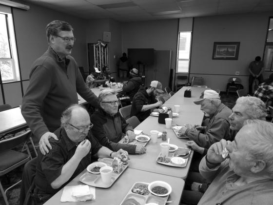 Assembly of God Superintendent Winston Titus visiting with some of the Drayton men. Photo by Tanio DeSousa.