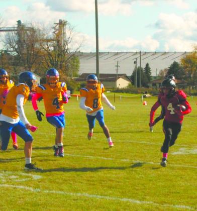 Being chased by Trenton defenders, senior Trypp Castillo sprints down the sideline. Photo by Jamie Rarick.
