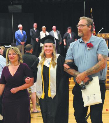 Rylee Maurstad exited the ceremony on the arms of her parents, Jamie and Ian Mattice. Photo by Andrea Johnston