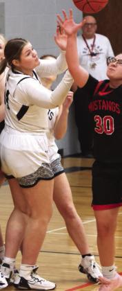 Alyvia Quibell fights Midway-Munto's Daisy Monson for a loose ball.