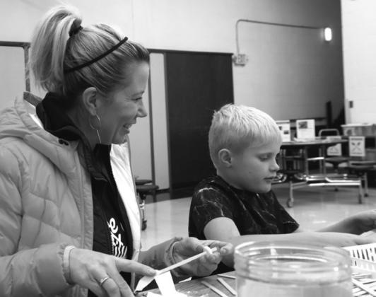 Janell Hilton and her nephew Hudson McFarland diligently working on a project at STEM night. Photo by Lyle Van Camp.