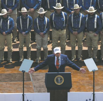 President Donald Trump speaks to a crowd July 1, 2026, at the Burning Hills Amphitheatre in Medora, N.D., in front of people portraying Theodore Roosevelt’s Rough Riders. Photo by Kyle Martin/For the North Dakota Monitor