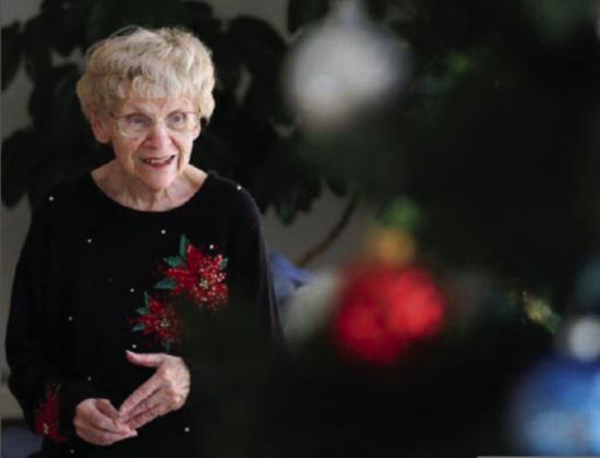 Saralee Hoselton at the end of December posing amid Christmas decorations in the community room of her Drayton apartment complex as she discusses her next column. Photo by Eric Hylden, Grand Forks Herald