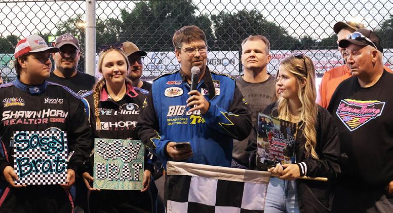 Tucker and Kelsi Pederson hold Sassy Brat Racing signs while Joey Pederson accepts the post-humous induction for his wife, Julie Pederson while surrounded by family and friends. Photo by Rebecca Davis
