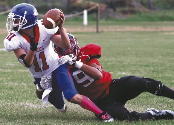 Mason Pollestad wraps up Center-Stanton's Hudson Buchholz-Casson. Photo by Lyle Van Camp