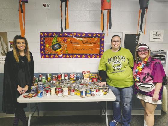 Drayton Booster Club members Jessica Woinarowicz, Jenny Uggerud, and Bryanna Halvorson are pictured with some of the food donations that will be donated to the Pembina County Emergency Food Pantry.