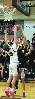 DVE's Isaac Feltman goes for the shot over Cavalier's Breckon Thorpe. Photo by Jamie Rarick
