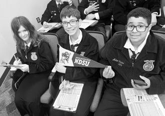 From left to right: Brooklyn Petersen, Jonah Rarick, and Jeremiah Johnson studying at the FFA State Convention. Photo by Adam Riddle.