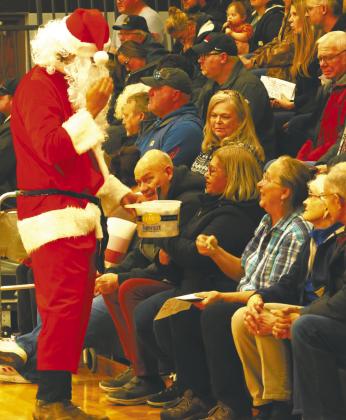 Santa Claus passed out treats to the audience during the Christmas play. Photo by Lyle V an Camp