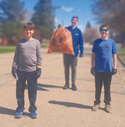 Ezra Adkins, Jonah Rarick, and Jasper Halvorson did their part to clean up the town. Photo by Christine Jensen