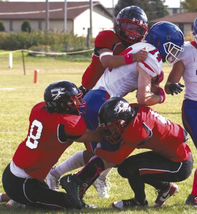 Three Bombers defenders stop the ball carrier in a group effort. Photo by Lyle Van Camp