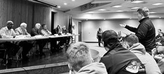 Bridger Rivinius, 4-H member from Stutsman County, stands to ask a question of North Dakota legislators during a panel discussion. (NDSU photo)