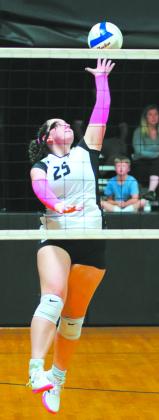 DVE senior Christine O'Toole extends for the spike. Photo by Larry Stokke.