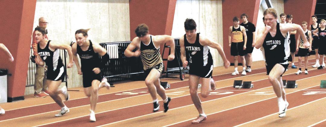 Pushing off the blocks, three Titan sprinters, Carter Johnson, Brady Reilly, and Carter Oberg, race to the finish line during the boys 60 meter dash. Photo by Jamie Rarick