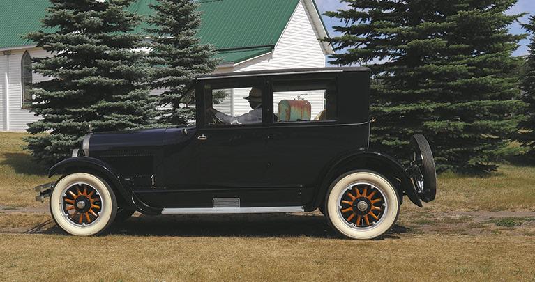 G.B. Gunslogon (Curtis Olafson) takes a visitor on a Sunday drive in the 1925 Case Model X Suburban Coupe. Photo by Rebecca Davis