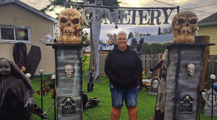 Kristi Juhl stands amidst some of the decorations she uses every year to transform her residence for local trick-or-treaters. Photo by Christine Jensen.
