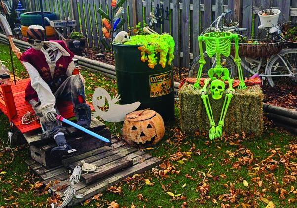 A pirate and green skeleton lounge beside some oozing (fake) biohazardous waste amidst Kristi Juhl’s elaborate Halloween displays. Photo by Christine Jensen. elaborate creations.
