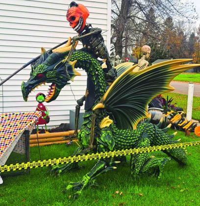 A jack-o-lantern skeleton rides upon a dragon, which blows smoke, lights up, and even roars on Halloween night. Photo by Christine Jensen.