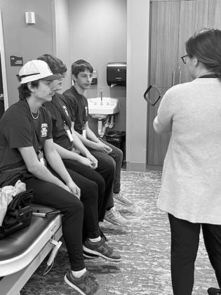 Trenten Keenan, Bradon Krimpel, and Carter Johnson learning about physicial therapy. Submitted Photo