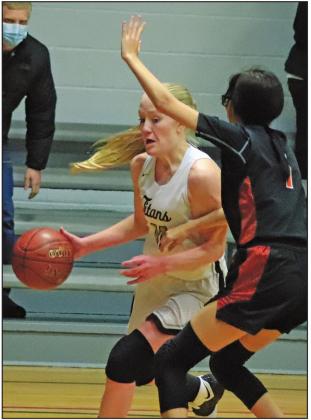Meghan Lorton heads for the basket to put up two while being defended by Warrior Bethany Brown. VNV Photo by Lesa Van Camp