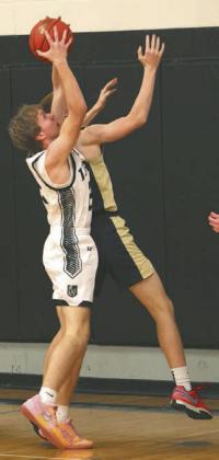 Carter Oberg fights a North Border defender for a rebound late in the game.