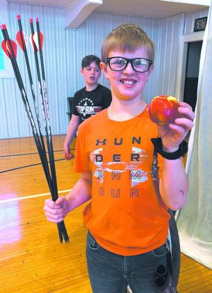 Levi N. shows off the apple he knicked with the arrow. Submitted photo. Submitted photo.
